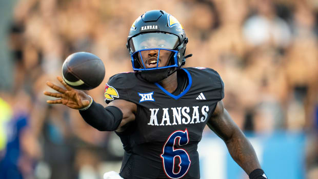 Sep 8, 2023; Lawrence, Kansas, USA; Kansas Jayhawks quarterback Jalon Daniels (6) pitches the ball during the first half against the Illinois Fighting Illini at David Booth Kansas Memorial Stadium. Mandatory Credit: Jay Biggerstaff-USA TODAY Sports  